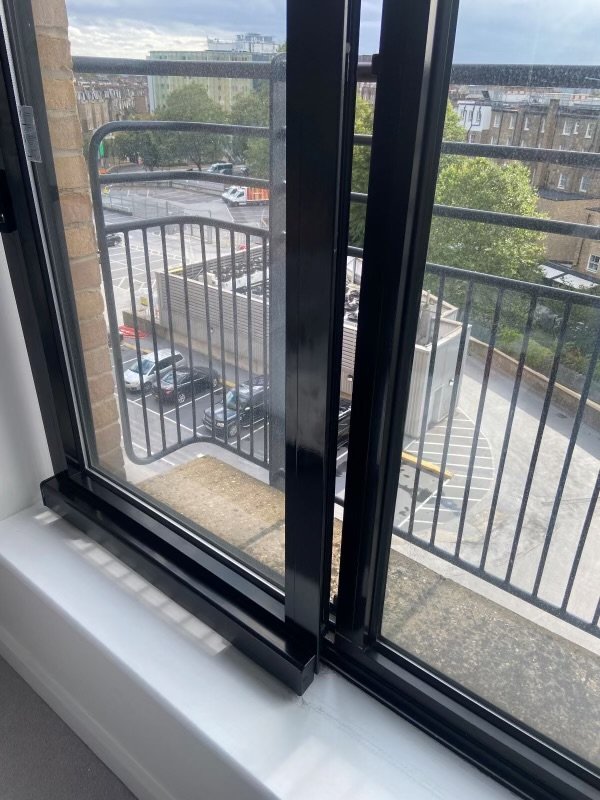 Window lock installed on Black framed windows