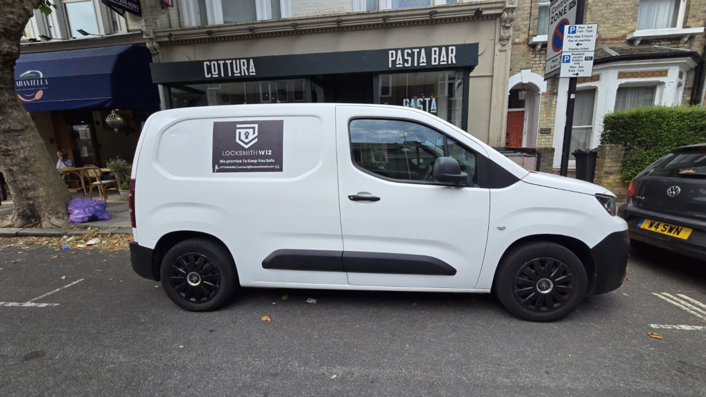Our white van with a black background logo in front of a shop. Locksmith west London | Locksmithw12