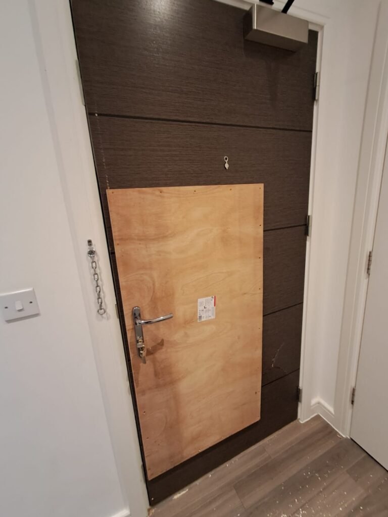 Boarding up a brown door. Provisory work until the new door arrives